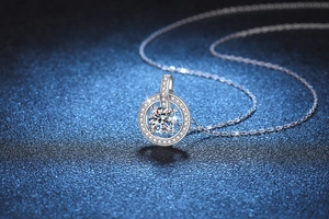 Macro shot of silver necklace featuring a sparkling round-cut moissanite pendant detail