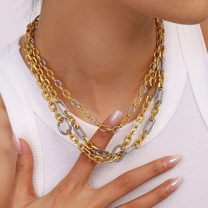 Layered gold and silver stainless steel necklace set worn by a model for a luxury look
