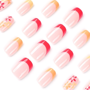Pink French press-on nails with red and orange floral designs and square-oval shape