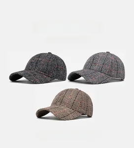 Three checkered tweed baseball caps in grey, blue, and brown plaid patterns