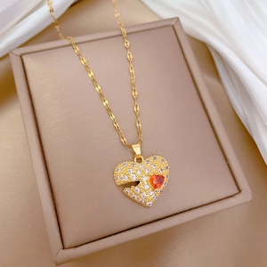 Close-up of a heart pendant necklace with white diamonds and orange center stone