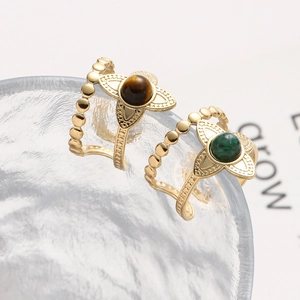 Detail of adjustable gold floral rings with tiger eye and green malachite stones