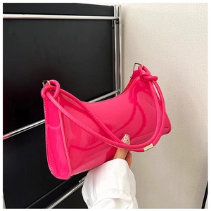 Detailed view of the glossy hot pink patent leather finish and knotted strap design