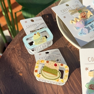 Pastel strawberry ice cream hair clips and claw clips set in a cafe setting