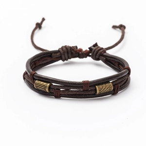 Detail of adjustable brown leather woven bracelet with geometric brass beads on white background