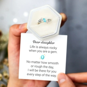 Detail of S925 silver leaf ring with blue gemstone in a gift box with a note card