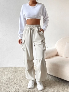 Women's vintage high-waist cargo pants with loose wide-leg fit and matching white sweatshirt