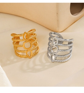 Macro detail of 18K gold and silver plated geometric hollow rings with rope texture
