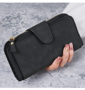 Detail of a black long PU leather wallet with multiple card slots and buckle closure