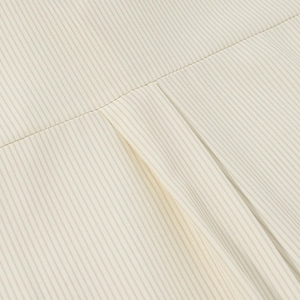 Detailed close-up of cream white striped fabric texture and premium stitching quality