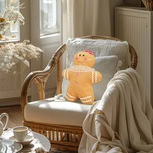 Detail of gingerbread man plush pillow with red bow tie on a cozy wicker chair