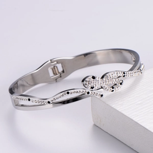 Close-up of snake-shaped titanium steel bracelet with spring clasp and crystal inlay