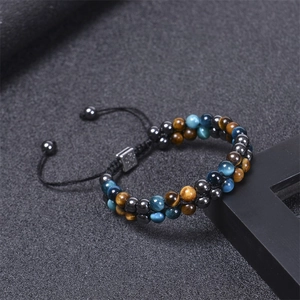 Macro detail of hand-woven double layer blue tiger eye and magnetic stone bead bracelet