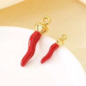 Macro shot of red chili pendants with gold crowns in two sizes for DIY jewelry
