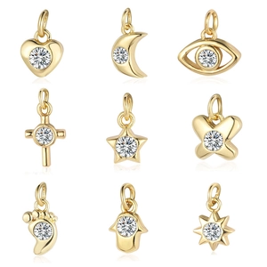 Golden copper charms collection with butterfly, moon, and eye designs with cubic zirconia