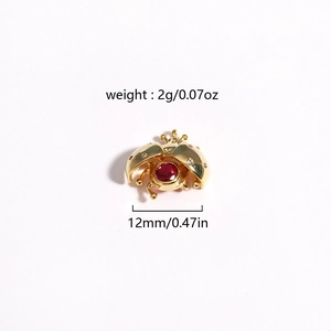 Macro shot of gold ladybug pendant with red gemstone and precise weight dimensions