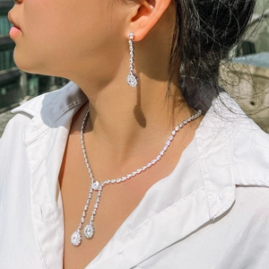 Elegant silver teardrop jewelry set with zircon necklace and earrings on model