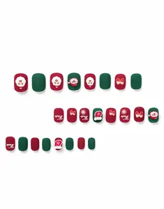 Detailed view of short Christmas themed press-on nails with Santa and snowflake motifs