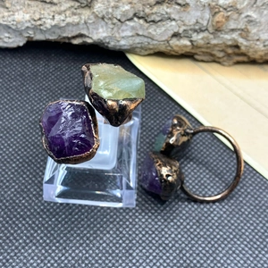 Detailed macro of vintage bronze ring featuring raw purple amethyst and green fluorite stones