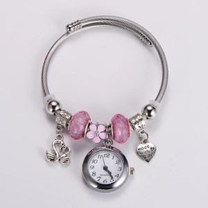 Detail of adjustable stainless steel charm bracelet watch with swan and heart pendants