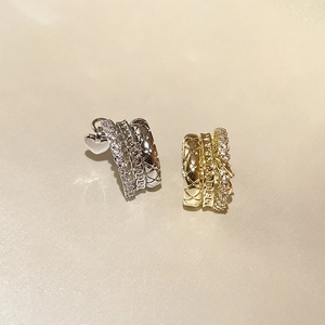 Three-layer metal heart earrings set with sparkling cubic zirconia in gold and silver finish