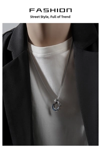 Detailed close-up of three interlocking steel rings pendant in silver blue and black