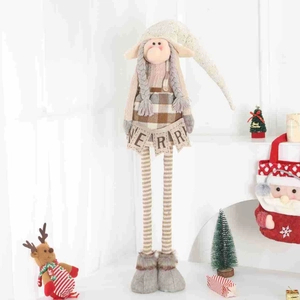 Detail of Christmas gnome doll with long legs holding a decorative Merry flag banner