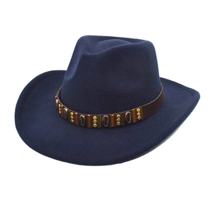 Detail of dark blue wool cowboy hat with leather band, gold rivets and shell ornaments