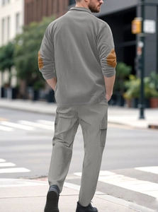 Rear view of men's casual grey corduroy set showing brown elbow patch details outdoors