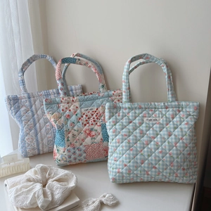 Three quilted cotton handbags with floral patterns and minimalist simple wish labels