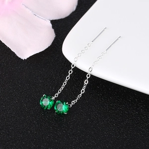 Detail of S925 silver long drop tassel earrings with sparkling green zircon stones