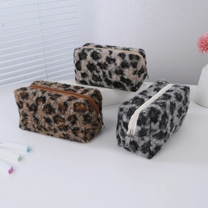 Three plush leopard print makeup bags in different colors with zip closures
