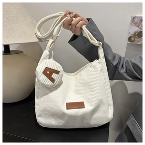 Detail of white corduroy tote bag with round coin purse and A-letter applique