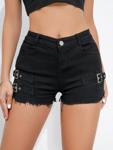 Close-up of black high-waisted denim shorts with side buckles, ripped holes and raw hem