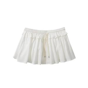 Detail of white pleated mini skirt featuring elastic waistband and drawstring ties