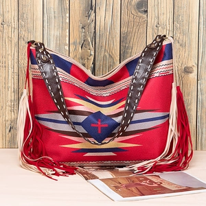 Detail of bohemian woven tote featuring ethnic patterns and long dual-tone tassels