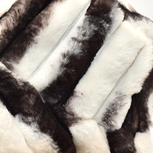 Macro view of plush faux fur texture with striped pattern and metallic zipper detail