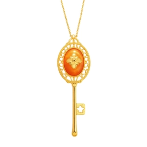 Vintage style gold resin key pendant necklace with star cutout and filigree design