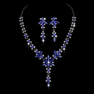 Close-up of elegant bridal jewelry set featuring blue crystals and silver-tone finish