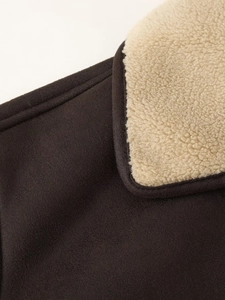 Close-up of dark brown faux leather jacket featuring a soft beige faux shearling collar