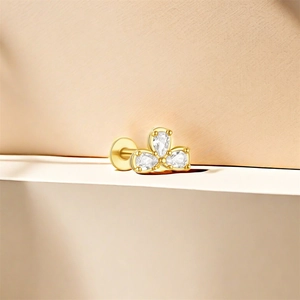 Detail of 925 sterling silver gold ear stud with three pear-cut zircon stones
