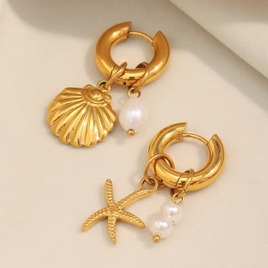 Close-up of 18K gold plated hoop earrings with starfish, shell and pearl charms