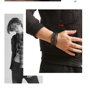 Detail of multi-layer black leather bracelet with metal studs on a male wrist