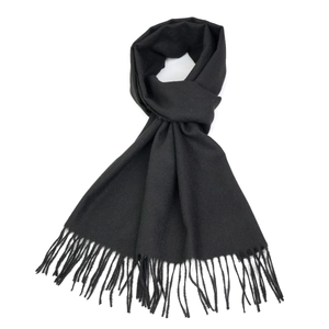 Detail shot of soft black cashmere-like winter scarf with fine fringe tassels on white background