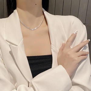 Elegant 925 sterling silver mesh necklace worn with a white suit blazer on a model