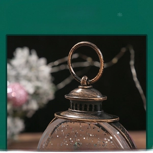 Detail of vintage bronze Christmas lantern with metal handle and glitter snowflake effect