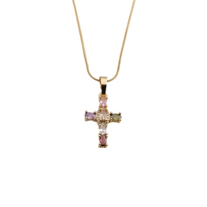 Détail du pendentif croix en cuivre avec zircons colorés sur une chaîne dorée