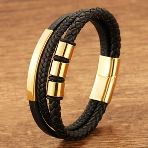 Men's multilayer black braided leather bracelet with gold magnetic clasp on wooden background