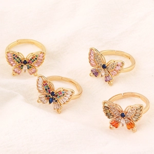 Macro detail of butterfly ring with colorful cubic zirconia and gold plating