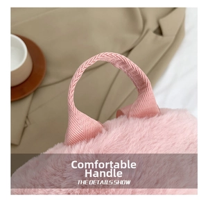 Close-up of pink lamb fleece backpack with reinforced woven handle and soft plush texture